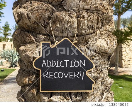 Addiction recovery symbol. Concept words Addiction recovery on beautiful black blackboard. Beautiful palm tree background. Psychology addiction recovery concept. Copy space. Addiction recovery symbol. Concept words Addiction recovery on beautiful black blackboard. Beautiful palm tree background. Psychology addiction recovery concept. Copy space. 138940055