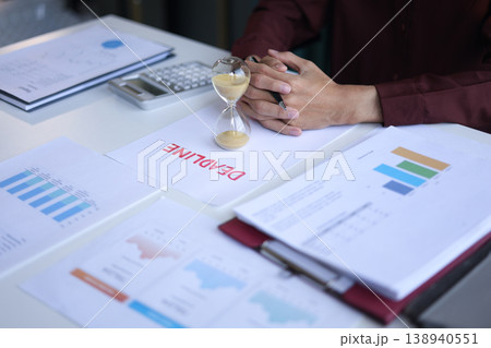 Businessman working on office desk with deadline document and running sand clock. Time management concept. 138940551