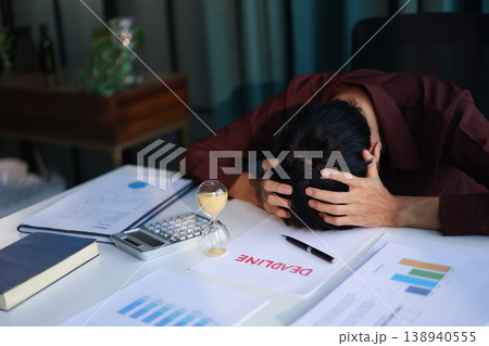 Businessman working on office desk with deadline document and running sand clock. Time management concept. Businessman working on office desk with deadline document and running sand clock. Time management concept. 138940555