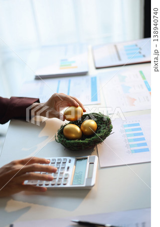 Businessman calculating and golden eggs on the table. wealth management and investment concept. 138940740