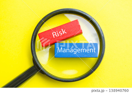 Risk Management text under magnifying glass representing risk assessment and control Risk Management text under magnifying glass representing risk assessment and control 138940760