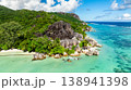 Granite rocks meeting turquoise water on a tropical coastline with lush greenery. Anse Source d'Argent. Seychelles, La Digue. 138941398