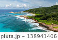 The turquoise ocean blending into the lush, green coastline with rocky formations. La Digue, Seychelles. 138941406