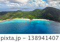 Turquoise waters meeting tropical green hills on a sunny coastline. La Digue, Seychelles. 138941407