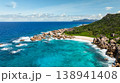 Granite coastline with clear turquoise waters, white sandy beach, and vibrant greenery. Anse Marron beach. La Digue, Seychelles. 138941408