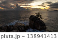 Solitary rock with palm trees amidst ocean waves at sunset. Seychelles, Mahe. 138941413