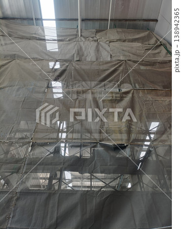 Industrial scaffolding construction safety net building renovation interior structure translucent tarp metal framework 138942365