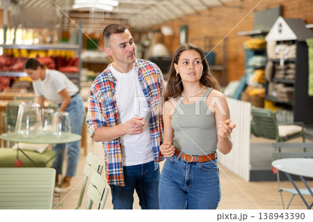 Spouses look for something in furniture store, searching for perfect item to complete patio 138943390