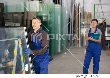 Glass factory - foreman controls the movement of finished window glass to warehouse Glass factory - foreman controls the movement of finished window glass to warehouse 138943598