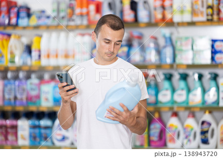 Young man scanning qr code for laundry detergentの写真素材 [138943720] - PIXTA