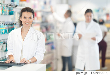 Portrait of friendly female pharmacist at the cash register in pharmacy 138943887