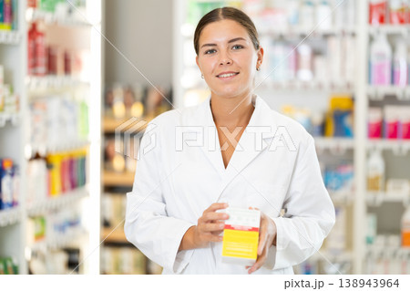 Young female pharmacist offering preparation in box Young female pharmacist offering preparation in box 138943964