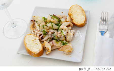 Grilled calamari and two pieces of bread served in a plate Grilled calamari and two pieces of bread served in a plate 138943992