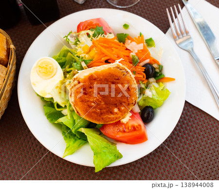 Goat cheese salad served with vegetables and herbs Goat cheese salad served with vegetables and herbs 138944008
