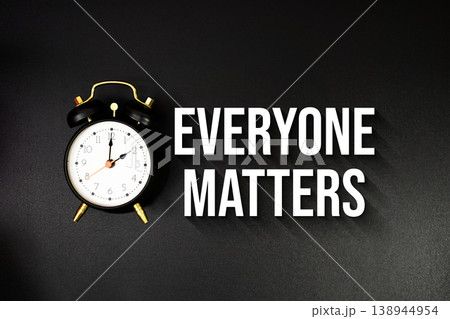 Everyone Matters text with alarm clock on black background 138944954