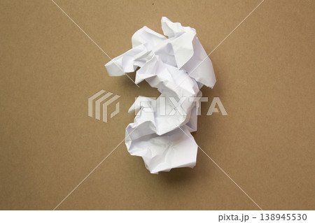 Crumpled paper isolated on brown background . Crumpled paper isolated on brown background . 138945530