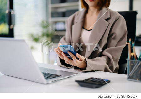 Businesswoman hand working digital marketing media in virtual screen with mobile phone and modern compute with VR icon diagram at office 138945617