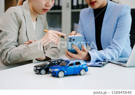 Car insurance consultation using smartphone and documents. Advisor and customer reviewing digital insurance service, auto policy, finance, technology Car insurance consultation using smartphone and documents. Advisor and customer reviewing digital insurance service, auto policy, finance, technology 138945640