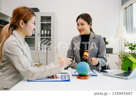 A lawyer presenting a green house model and earth globe with a gavel showing environmental law eco policy sustainability justice A lawyer presenting a green house model and earth globe with a gavel showing environmental law eco policy sustainability justice 138945687