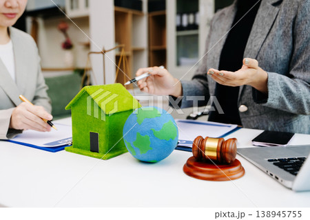 Eco business teamwork sharing the globe with green home, ESG values, legal support, property agreement and sustainable environmental responsibility. 138945755
