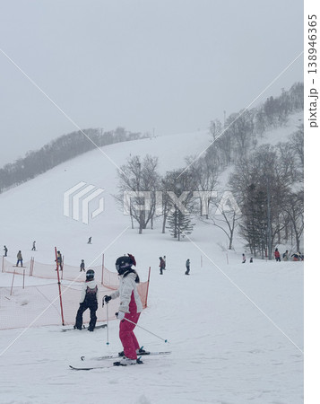 Niseko, Japan - April 3, 2025 : Snowboarders and skiers enjoy activities at Annupuri ski resort, Niseko, Hokkaido, Japan on April 3, 2025. 138946365
