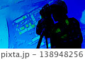 A surveyor against the background of infographics of project documentation, a dark figure of a human surveyor behindSurveyor silhouette mapa device performing geodetic work on engineering surveys 138948256