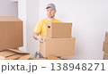Workers a loader brings boxes indoors when moving in close-up 138948271