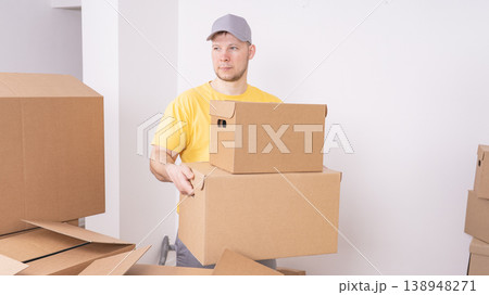 Workers a loader brings boxes indoors when moving in close-up 138948271