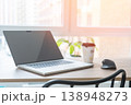 Laptop on the desk indoors, daylight from the window, coffee cup, mouse on the desk, workspace in a modern businessman. 138948273