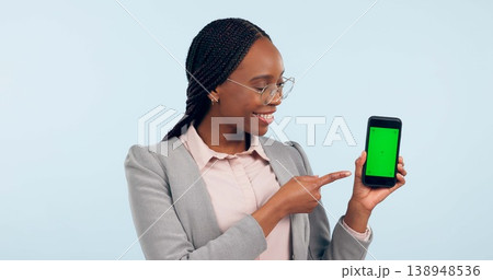 Black woman, pointing at smartphone and green screen, advertising mockup with tracking marker in studio. Information, marketing for app or website, communication and ads for tech on blue background Black woman, pointing at smartphone and green screen, advertising mockup with tracking marker in studio. Information, marketing for app or website, communication and ads for tech on blue background 138948536