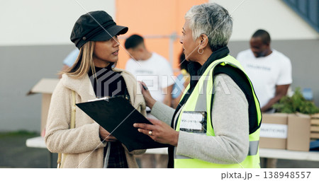 Women volunteering, checklist and food donation, NGO project or community service management and support. Nonprofit people or senior manager helping, talking and registration or clipboard for charity Women volunteering, checklist and food donation, NGO project or community service management and support. Nonprofit people or senior manager helping, talking and registration or clipboard for charity 138948557