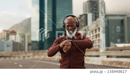 Man, music and smart watch in city for exercise, fitness performance and workout results. Happy senior african runner check timer, clock and healthy training progress with headphones in urban road 138948627