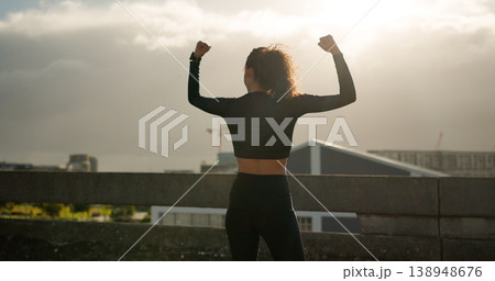 Woman, success and city for fitness achievement, workout or winning in outdoor training. Rear view of female person, runner or athlete in celebration for goals, sports or victory in an urban town Woman, success and city for fitness achievement, workout or winning in outdoor training. Rear view of female person, runner or athlete in celebration for goals, sports or victory in an urban town 138948676