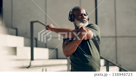 Fitness, headphones and senior black man stretching in city, workout and exercise for body health. Music, serious athlete and warm up on steps or stairs in urban town, listening to audio and thinking 138948723