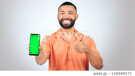 Portrait, man and thumbs up for phone with green screen, space and agreement in studio on white background. Happy model, smartphone and yes emoji for newsletter, promotion and advertising information Portrait, man and thumbs up for phone with green screen, space and agreement in studio on white background. Happy model, smartphone and yes emoji for newsletter, promotion and advertising information 138949572