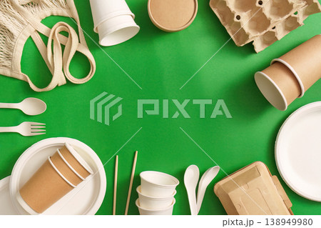 Sustainable packaging and utensils on green background 138949980