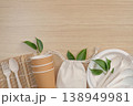 Eco-friendly tableware and reusable bag on wooden surface 138949981