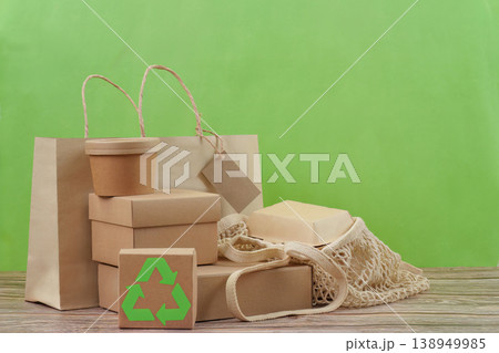 Recyclable packaging and reusable bag on green background 138949985