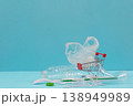 Plastic waste and shopping cart on blue background 138949989