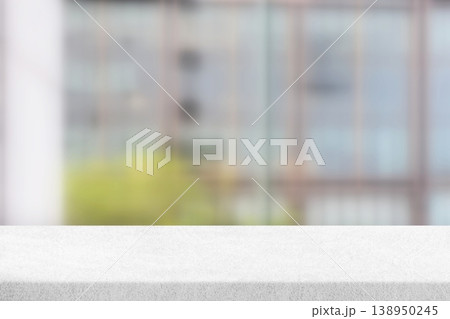 White textured tabletop surface against a blurred background, typically used as a mockup or product display setting. White textured tabletop surface against a blurred background, typically used as a mockup or product display setting. 138950245