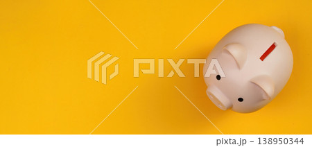 Piggy bank on a vibrant yellow background 138950344
