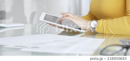 Woman working on digital tablet in office, accessing business documents and technology data. Audit and taxes in business 138950683