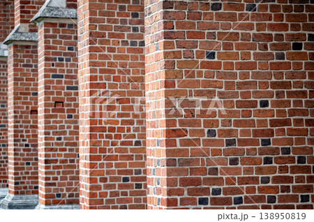 Bricks form a wall structure along the side of a historic building in a city Bricks form a wall structure along the side of a historic building in a city 138950819