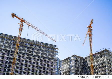 Construction of a building. Construction site with crane. Business, development, industry. 138950994
