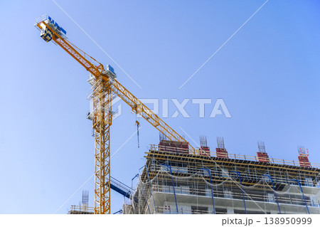 Construction of a building. Construction site with crane. Business, development, industry. 138950999