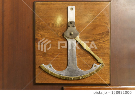 Vintage clinometer mounted on wooden panel, antique angle measuring instrument Vintage clinometer mounted on wooden panel, antique angle measuring instrument 138951000