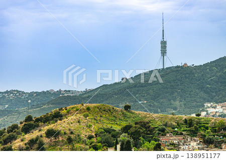 Collserola Tower on mountain landscape in Barcelona with green hills and urban outskirts Collserola Tower on mountain landscape in Barcelona with green hills and urban outskirts 138951177