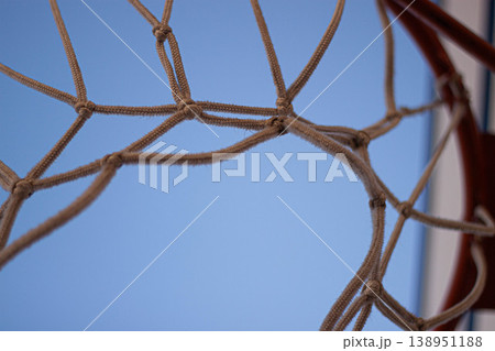 Close-up of basketball hoop net with blue background Close-up of basketball hoop net with blue background 138951188
