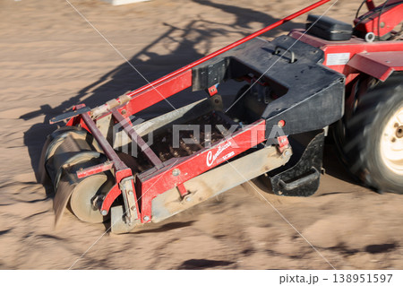Egypt, Sharm el-Sheikh - September 26, 2025 A man pushes a sand cleaning machine on the beach. Editorial 138951597