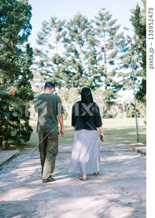 Couple walking forward on bridge toward green field, future together concep 138952478